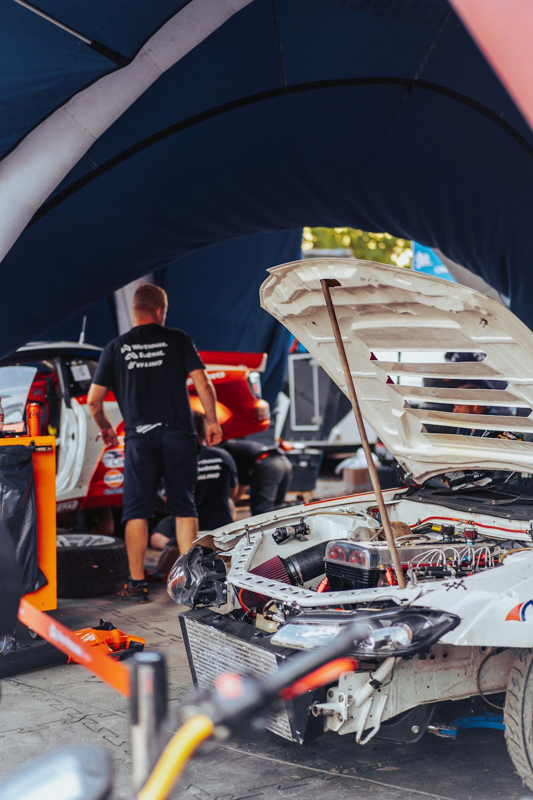 contact-img a-white-car-with-a-hood-open-in-a-garage-a5jshu2xlyi